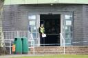 A police officer stands at the entrance to Amman Valley School, in Ammanford, Carmarthenshire (Ben Birchall/PA)