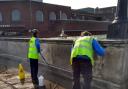 Neighborhood Rangers removing offensive graffiti on a bridge in the town centre. Image: RBK via Twitter