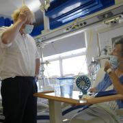 Prime Minister Boris Johnson meets patient Rita Thomson, after she had a complete hip replacement, during a visit to the South West London Elective Orthopaedic Centre in Epsom to see how their work is contributing towards busting the Covid backlog / PA