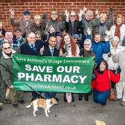 Abdool Kureeman, Gillian Russell and Ashtead residents celebrate after the NHS approved Mr Kureeman's second application to open a new pharmacy in the village