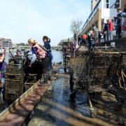 Students clear out shopping trolleys from the Thames