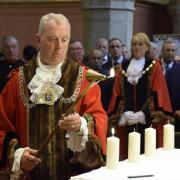 Kingston mayor Ken Smith lights one of 11  candles at All Saints Church