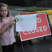 Quick thinking Hannah with her sign, ready to give directions to confused drivers