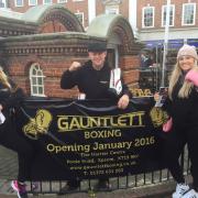 From left, Pip Smith, 22, Chris Gauntlett, 49, and Chloe Gauntlett, 22, advertise the new Gauntlett Boxing Club
