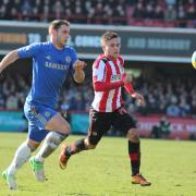 Branislav Ivanovic chases Brentford's Harry Forrester in the FA Cup 4th Round at Griffin Park in 2013