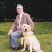 Chris Gilroy with one of his guide dogs, Bailey