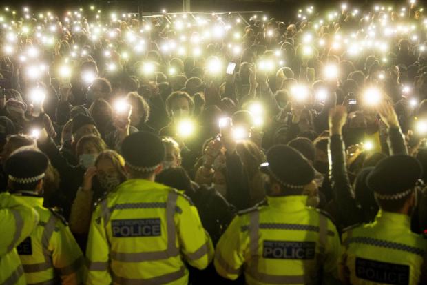 Surrey Comet: People in the crowd turn on their phone torches as they gather in Clapham Common, London, for a vigil for Sarah Everard