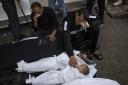Members of the Abu Draz family mourn their relatives killed in the Israeli bombardment of the Gaza Strip, at a hospital morgue in Rafah, southern Gaza Strip, Thursday, April 4, 2024.