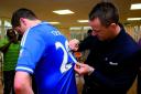 Chelsea through and through: John Terry signs a fan's shirt