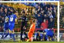 Big moment: Paul Robinson, grounded, bundled home the only goal in the Dons 1-0 win over Carlisle United on Tuesday night