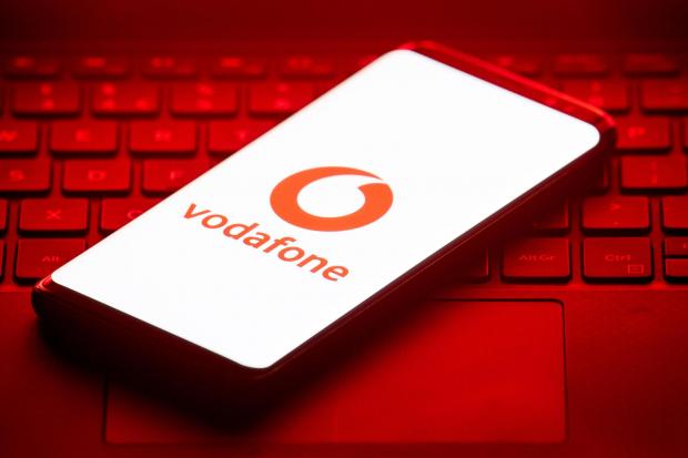 Surrey Comet: Vodafone logo on a phone placed on a keyboard. Credit: PA