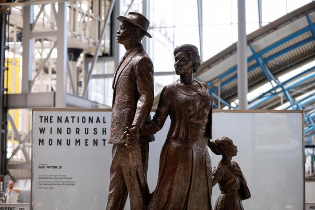 Surrey Comet: The National Windrush Monument at Waterloo Station. The statue - of a man, woman and child in their Sunday best standing on top of suitcases - was designed by the Jamaican artist and sculptor Basil Watson