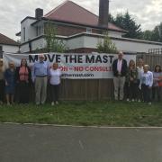 Residents with 'move the mast' banner
