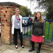 •	Poppy display at the entrance of Epsom Hospital - Sophie Bevan, Head of Patient Experience and Partnership and Jo Brittan Patient Experience Manager. Image: ESHT
