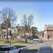 The victims were assaulted at the traffic lights on Claremont Lane's junction with Esher High Street.
