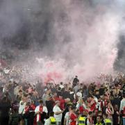 Southampton fans run onto the pitch after victory in the Sky Bet Championship play-off, semi-final, second leg match at St Mary’s Stadium (PA)