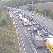 A crash on the M25 between Surrey and Kent has led to long traffic queues and delays of up to 30-minutes with two lanes closed.