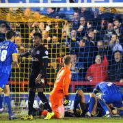 Big moment: Paul Robinson, grounded, bundled home the only goal in the Dons 1-0 win over Carlisle United on Tuesday night