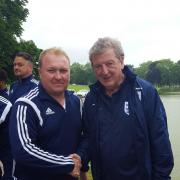 A meeting of great minds: Epsom & Ewell boss Glyn Mandeville grants England boss Roy Hodgson a photo while out in Chantilly for a friendly match