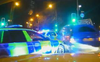 He reversed into a police car and then drove forward into another, injuring an officer / Surrey Police